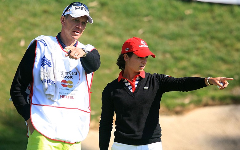 Lorena Ochoa of Mexico talks with her caddie Dave Brooker on the fourth green during the first round of the MasterCard Classic.