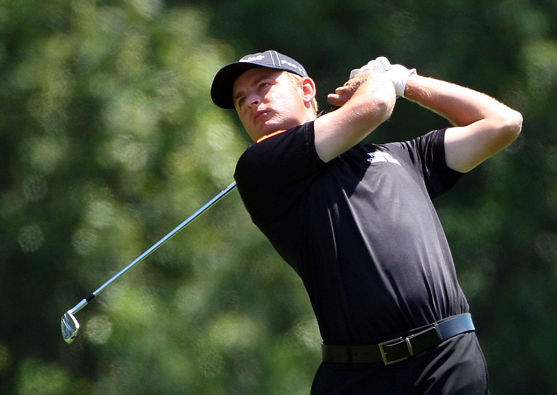 John Merrick hits his approach shot on the first hole during the final round of the 2009 Masters Tournament.