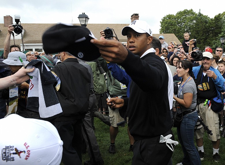 Tiger Woods signs some autographs during a practice round at the U.S. Open.
