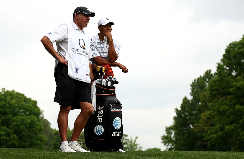 Tiger Woods of the USA and his caddy Steve Williams wait on the 5th fairway during the first round of the Quail Hollow Championship.