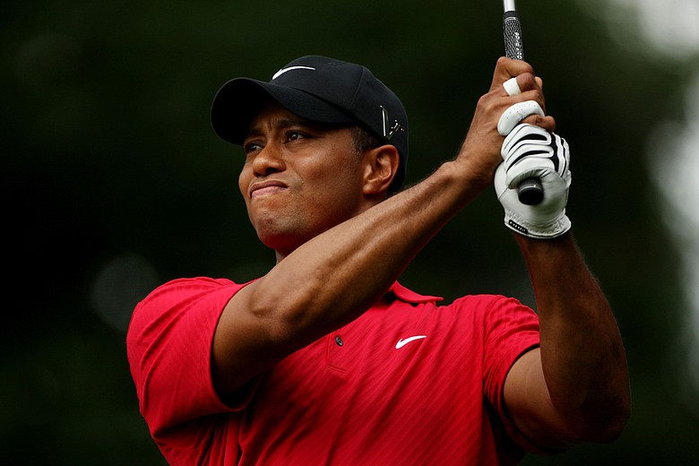 Tiger Woods watches his tee shot on the eighth hole during the continuation of the third round of the 109th U.S. Open.