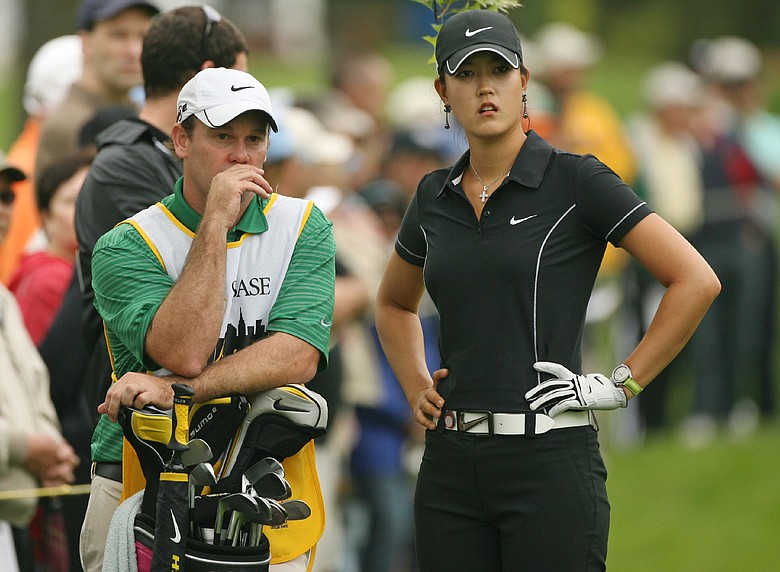 Michelle Wie and her caddie Gary Matthews discuss a shot.