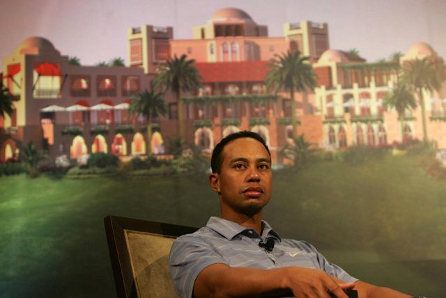 Tiger Woods in front of a poster showing the planned development of the Tiger Woods Dubai community at a venue in Dubai.