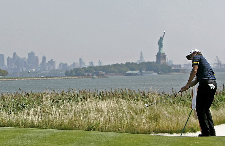 Adam Scott chips on the 14th green at Liberty National Golf Club Aug. 26.