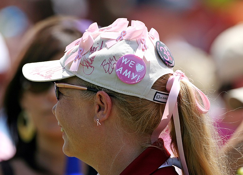 A tournament volunteer wears pink ribbons and a 'We Love Amy' button on her hat to show her support for Amy Mickelson and breast cancer research during the third round of the Crowne Plaza Invitational at Colonial Country Club.