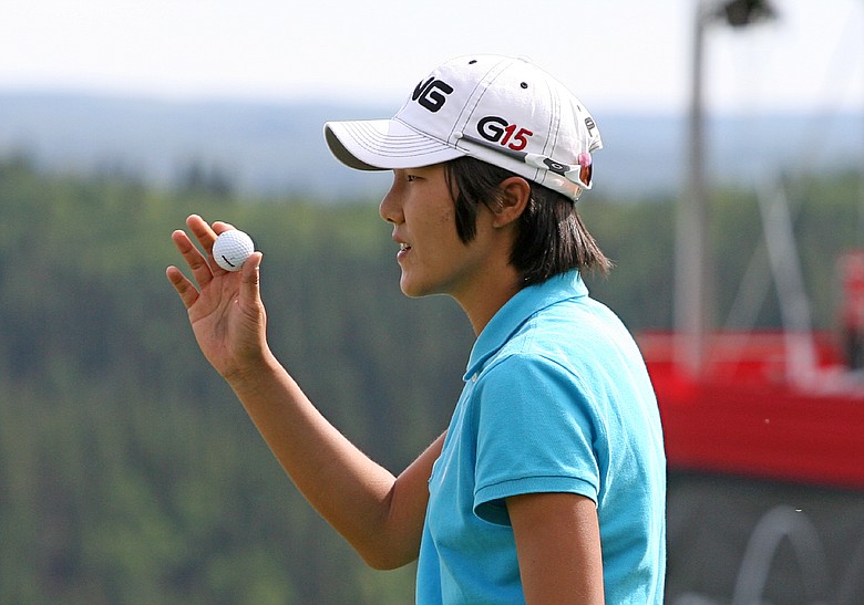 Song-Hee Kim of South Korea waves to the crowd on the 18th green during the second round of the Canadian Women's Open at Priddis Greens Golf & Country Club on September 4, 2009 in Calgary, Alberta, Canada.