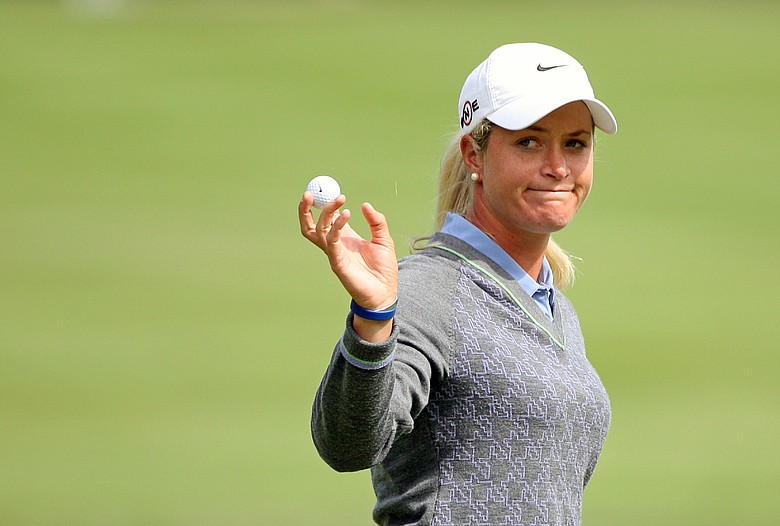 Suzann Pettersen of Norway waves to the crowd on the ninth green during the Canadian Women's Open at Priddis Greens Golf & Country Club in Calgary, Alberta, Canada.