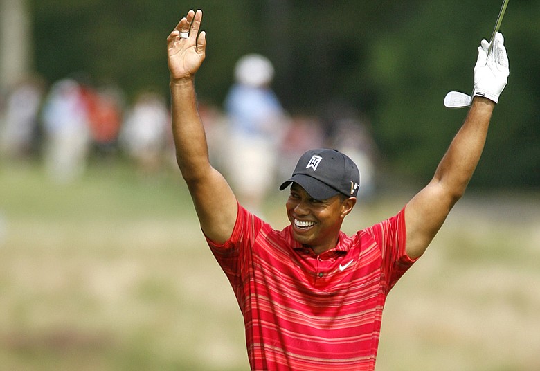 Tiger Woods celebrates after holing out for eagle on the par-4 sixth hole at TPC Boston.