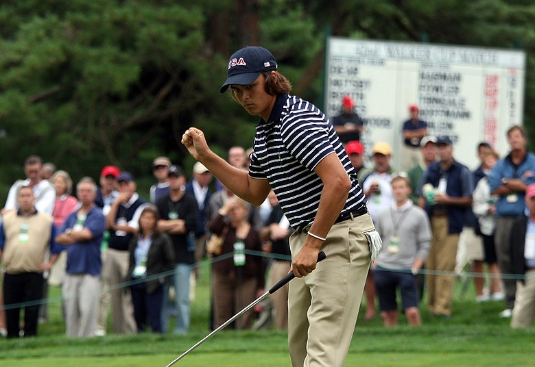 Rickie Fowler holes a birdie putt to win his match against Sam Hutsby of England, 7 and 6, on the 12th green during the afternoon singles matches at the Walker Cup.