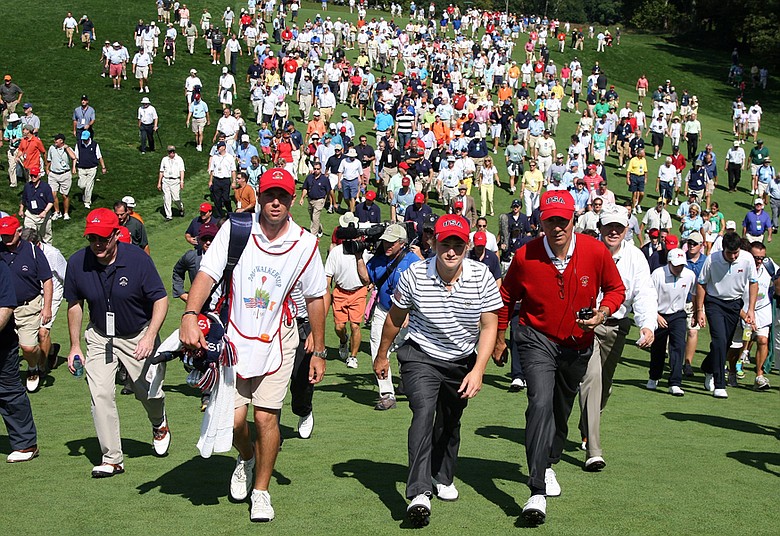 Bud Cauley and captain Buddy Marucci walk ahead of the huge gallery at the 18th hole on Sept. 13.