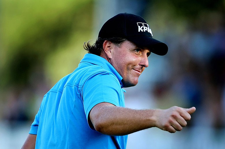 Phil Mickelson walks off the 18th green after winning The Tour Championship.