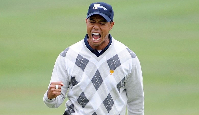 Tiger Woods celebrates his birdie putt that won 17th hole Oct. 10 at the Presidents Cup.