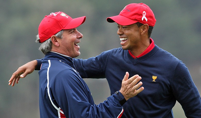Fred Couples congratulates Tiger Woods after he holed the winning putt for the Americans at the Presidents Cup.