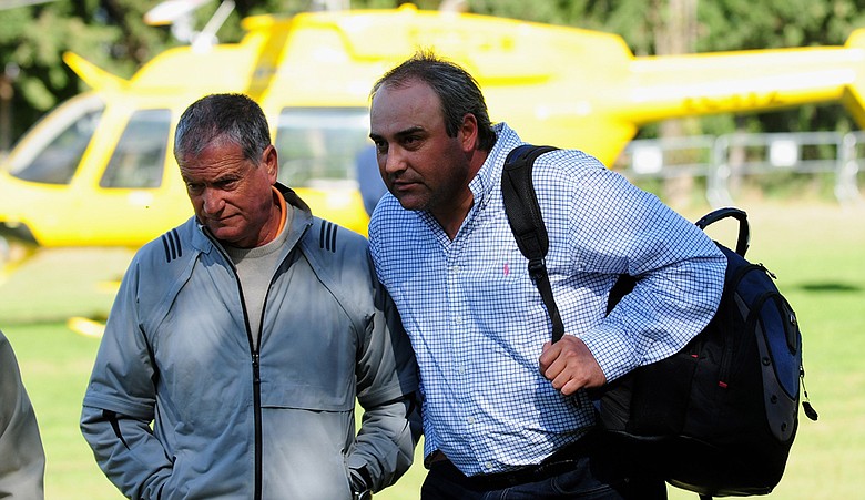 Angel Cabrera is greeted by Victor Garcia, Sergio Garcia's father, after his helicopter was delayed due to strong winds. Cabrera was disqualified for missing his tee time.