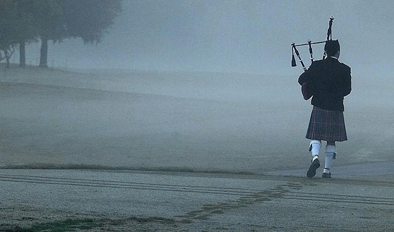 Bagpiper Steve Agan plays "Going Home" as he leaves a memorial service for Payne Stewart at the Tour Championship in Houston on Oct. 28, 1999.