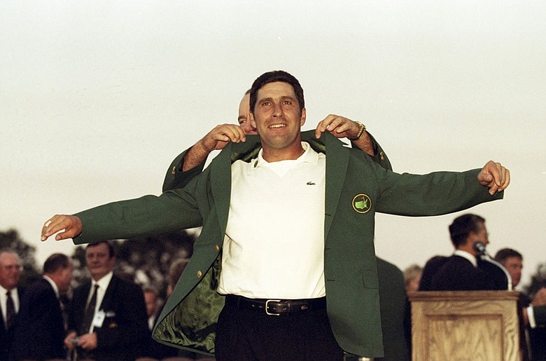 Jose Maria Olazabal puts on the green jacket after winning the 1999 Masters.
