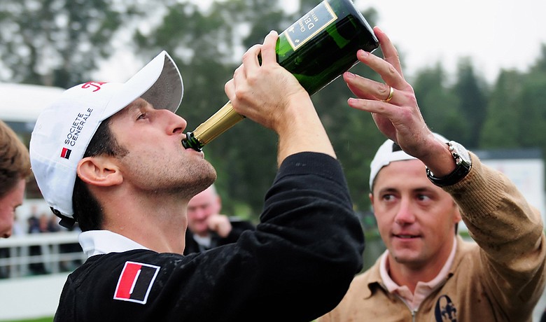 Gregory Bourdy celebrates with champagne from fellow french player Jean Lucquin on the 18th hole after winning the Hong Kong Open on Nov. 15.