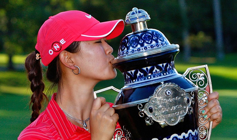 Michelle Wie kisses the trophy after winning the Lorena Ochoa Invitational on Nov. 15.