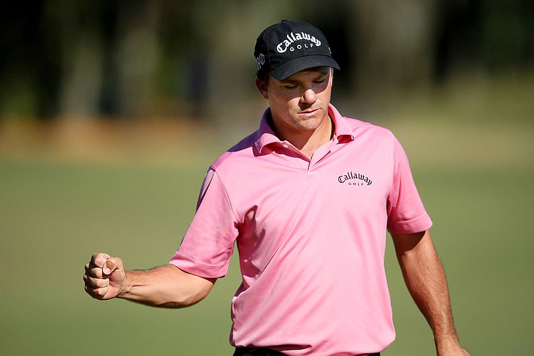 Nicholas Thompson pumps his fist after making a 9-footer for bogey on No. 18.