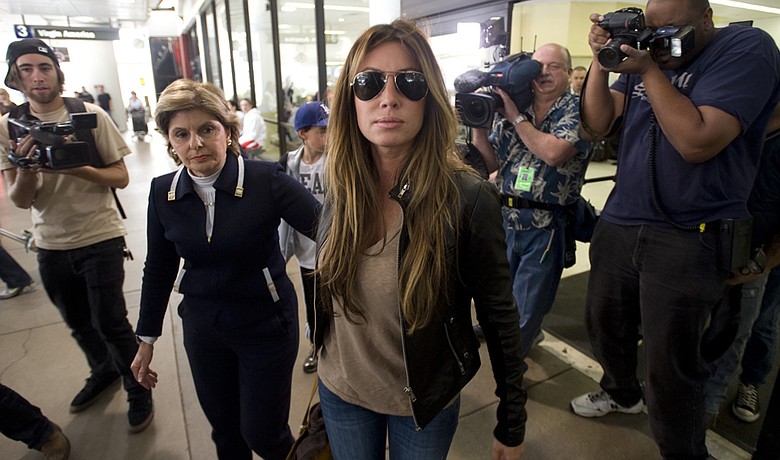 Rachel Uchitel arrives from New York at the Los Angeles International Airport on Nov. 29. Gloria Allred, left, met her at the airport.