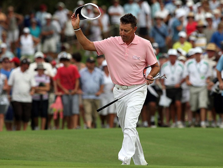 Robert Allenby acknowledges the crowd as he walks up the 18th fairway Dec. 13 at Hyatt Regency Resort.