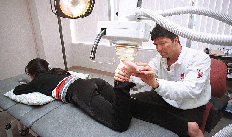 This Dec. 16, 1999, photo shows Dr. Anthony Galea treating a patient with shock wave therapy at the Institute of Sports Medicine in Toronto.