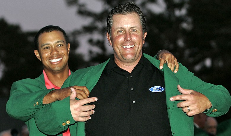 Phil Mickelson dons the green jacket after winning the 2006 Masters.
