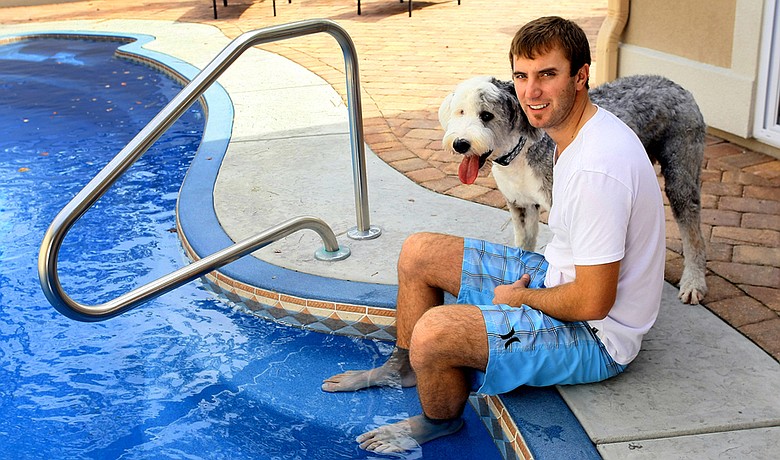Dustin Johnson with his dog, Max, at home in Myrtle Beach, S.C.