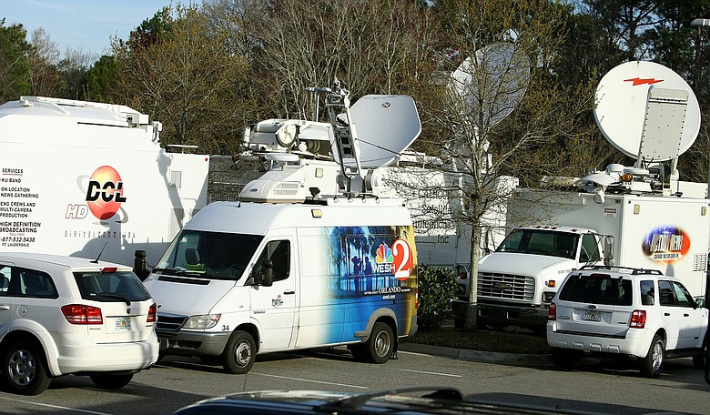 Satellite trucks en mass are parked outside Sawgrass at Marriott in Ponte Vedra Beach, Fla. for Tiger Woods' first public statement in three months.