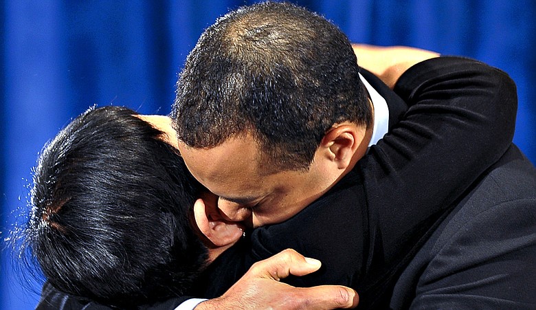 Tiger Woods and his mother, Kultida, hug after Tiger delivered a statement Friday.