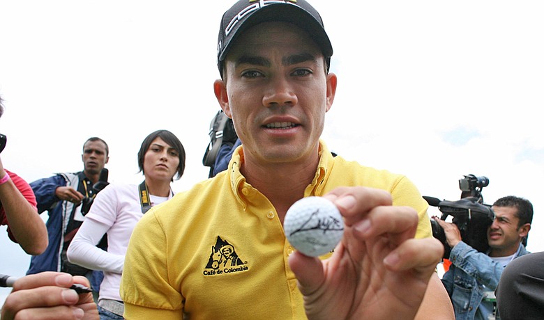 Camilo Villegas autographs a golf ball at golf exhibition in Bogota, Colombia, on March 2.