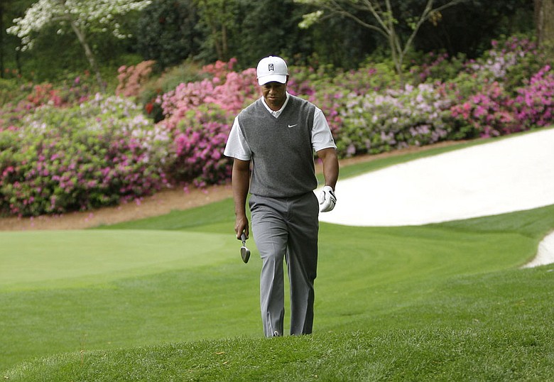 Tiger Woods walks off the 13th green at Augusta National during a practice round at the 2008 Masters.