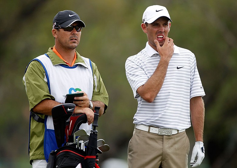 Charl Schwartzel talks with his caddie, Wynad Stander, on the fifth tee Thursday at Doral.