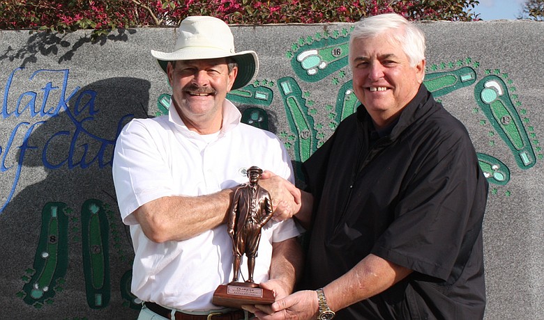 Rick Woulfe (left) accepts the Florida Azalea Senior Amateur trophy.