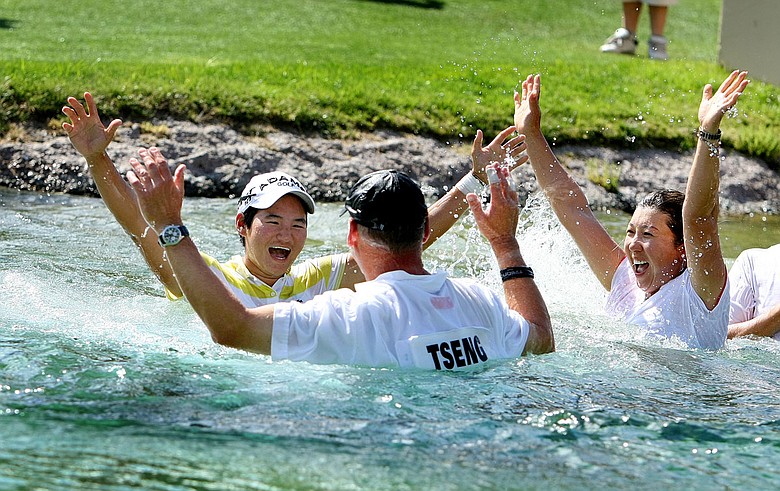 Yani Tseng celebrates after jumping into Poppie's Pond with her caddie, friends and family.