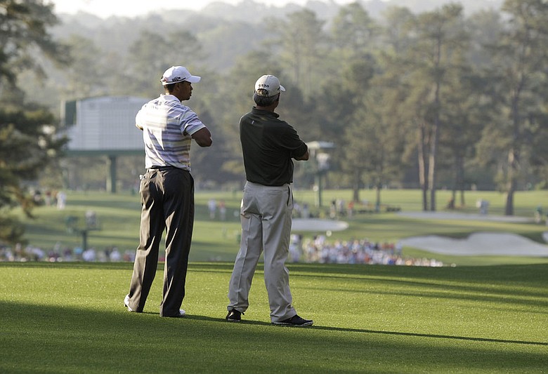 Tiger Woods talks with with Fred Couples in the second fairway during their Monday practice round at the Masters.