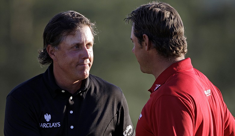 Lee Westwood (right) shakes hands with Masters champion Phil Mickelson on Sunday.