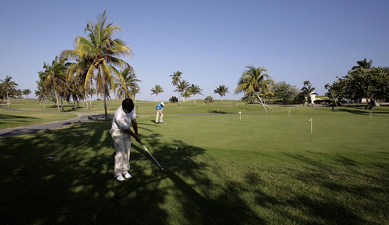 Players hit the practice green during the 2010 Montecristo Cup Golf Tournament in Varadero, Cuba
