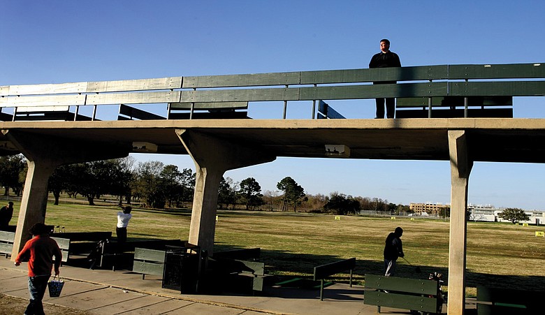 Don Tillar Jr., general manager of City Park's North Course, stands just above Katrina's high-water mark atop the park's double-decker range.