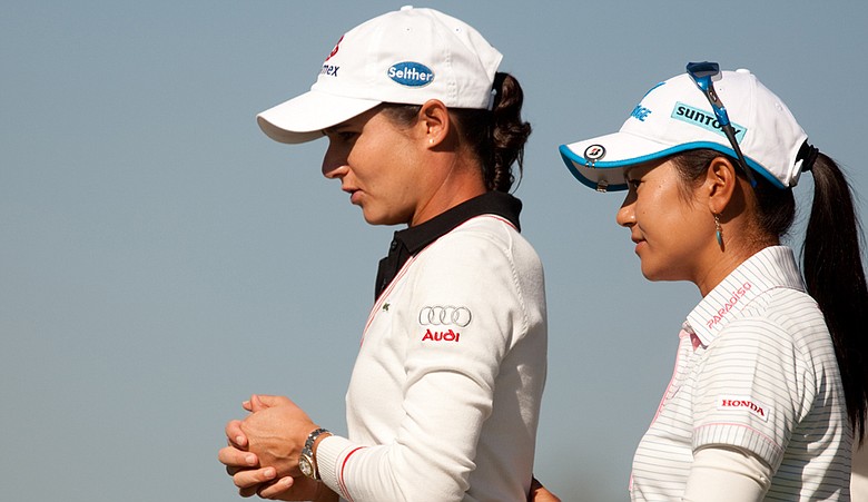 Lorena Ochoa and Ai Miyazato stand on the tee together during the Tres Marias Championship.