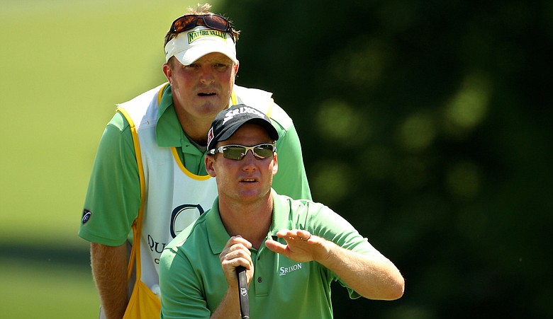 Garth Mulroy lines up a putt with his caddie during the second round of the Quail Hollow Championship.