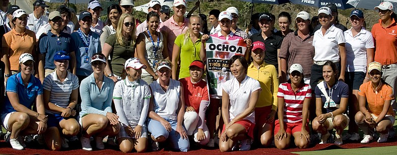Lorena Ochoa (center) poses for a picture holding a caddie vest she received as a farewell present after the Tres Marias Championship.