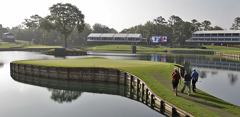 Tiger Woods, Pat Perez, J.J. Henry and Steve Williams walk to the 17th green during a practice round for The Players.