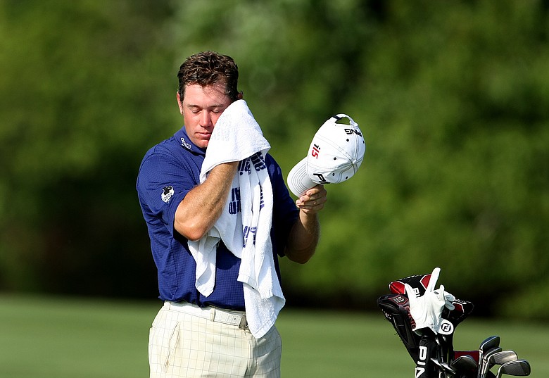 Lee Westwood wipes away sweat at No. 14. Temperatures were well into the 90s on Saturday.