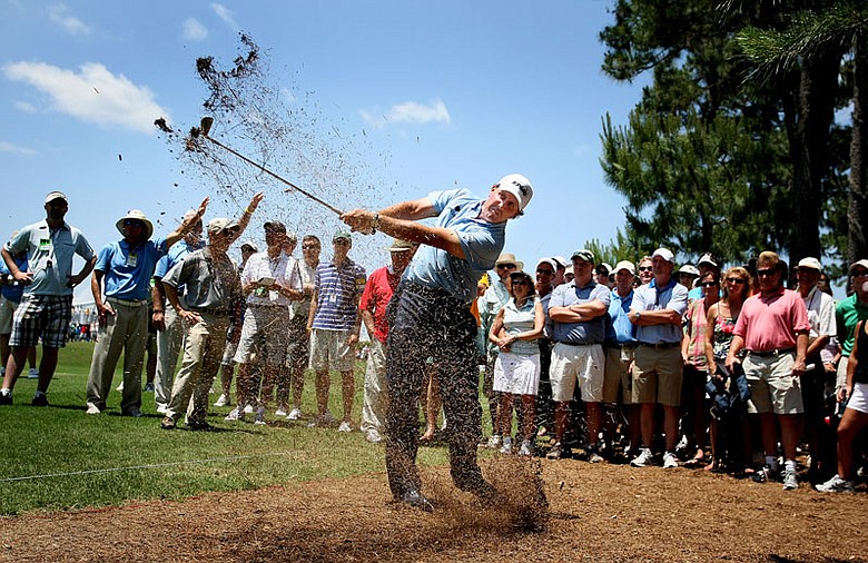 Phil Mickelson hits his second shot from pine straw at No. 16 Saturday at The Players.
