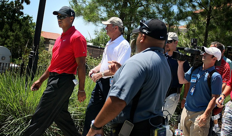 Tiger Woods walks off the course after withdrawing from The Players Championship on May 9.