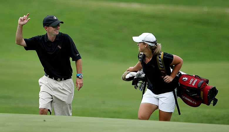 Assistant coach Chris Malloy walks with senior Lacey Agnew at the 18th.