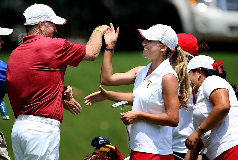 USC’s director of golf, Kurt Schuette (left) high-fives Belen Mozo after her second-round 72.