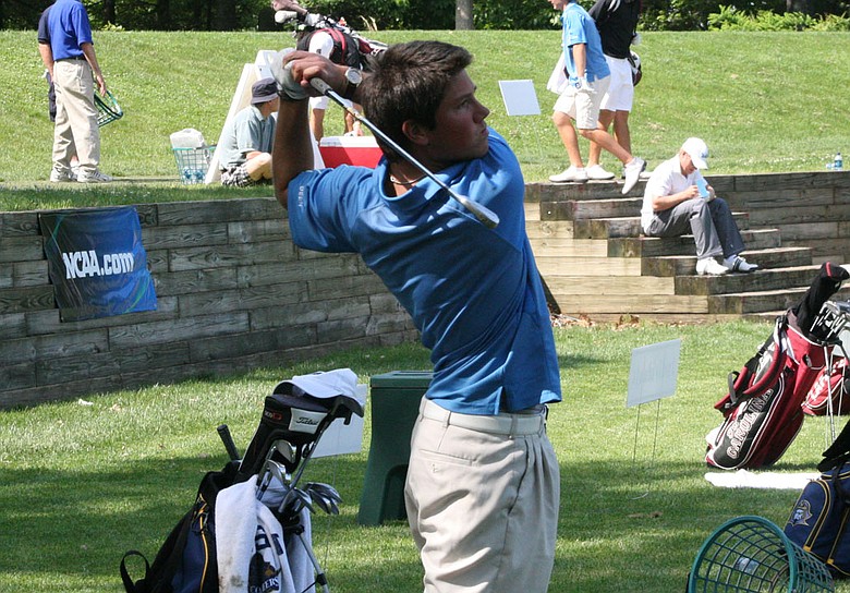 Rhys Enoch hits balls on the range at The Course at Yale after his second-round 68.