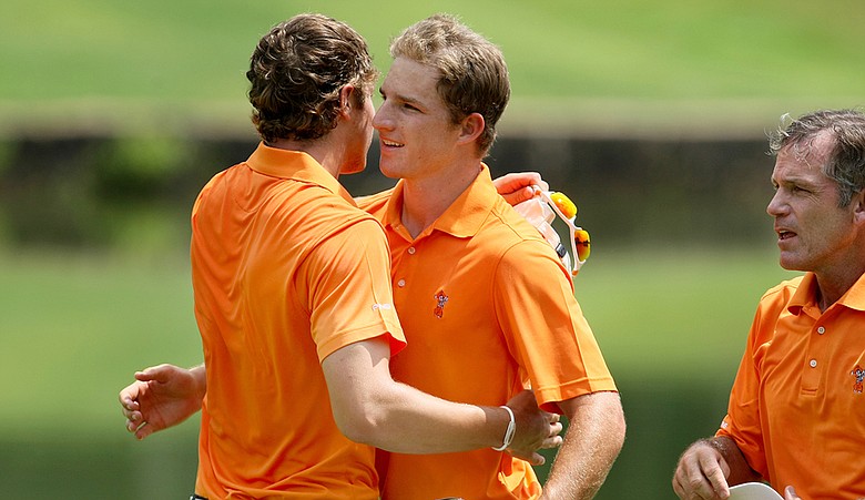 Peter Uihlein hugs Morgan Hoffmann as Oklahoma State advances to the NCAA Championship final.